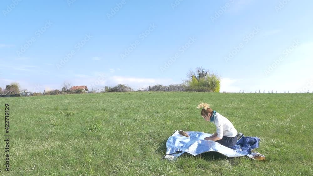 Slow motion: woman performing yoga pose outdoors in nature, on green grass meadow with mountains background. Wellbeing fitness concept Slow motion: woman performing yoga pose outdoors in nature, on green grass meadow with mountains background. Wellbeing fitness concept