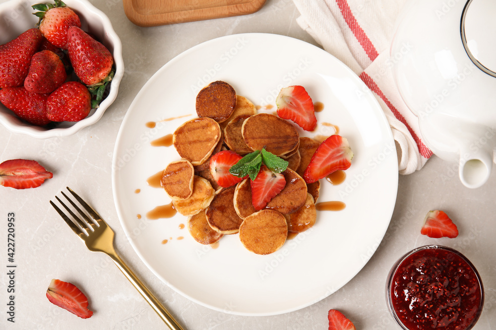 Cereal pancakes with strawberries on light grey marble table, flat lay Cereal pancakes with strawberries on light grey marble table, flat lay