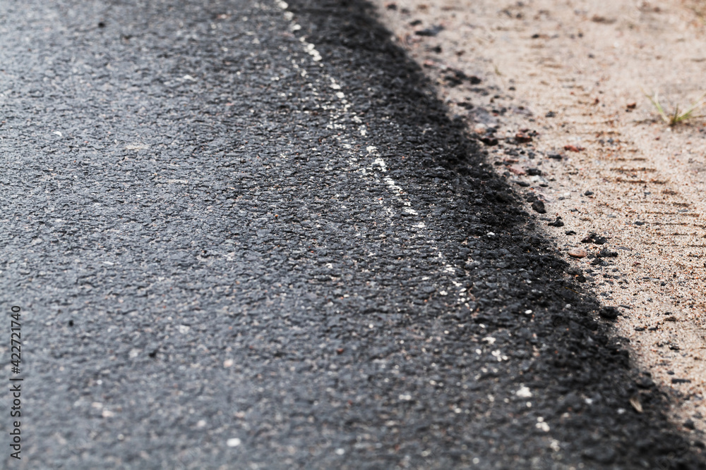 Asphalt road border and sandy roadside Asphalt road border and sandy roadside