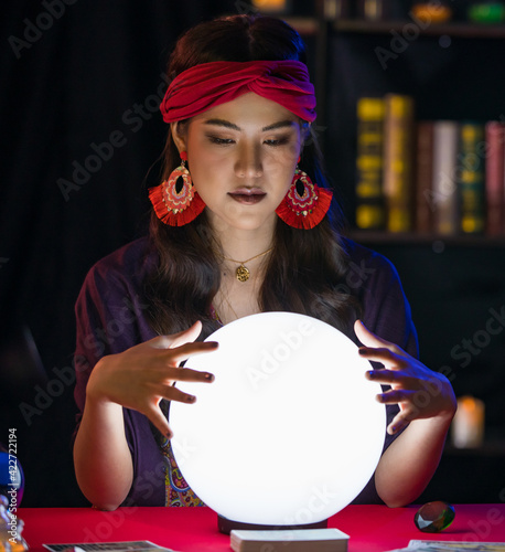 Fotografie Asian fortune teller in dark room