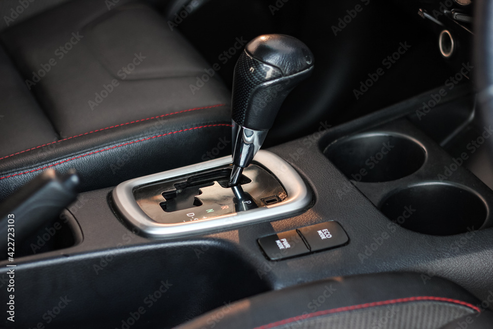 automatic transmission shift selector in the car interior. Closeup a manual shift of modern car gear shifter. automatic transmission shift selector in the car interior. Closeup a manual shift of modern car gear shifter.