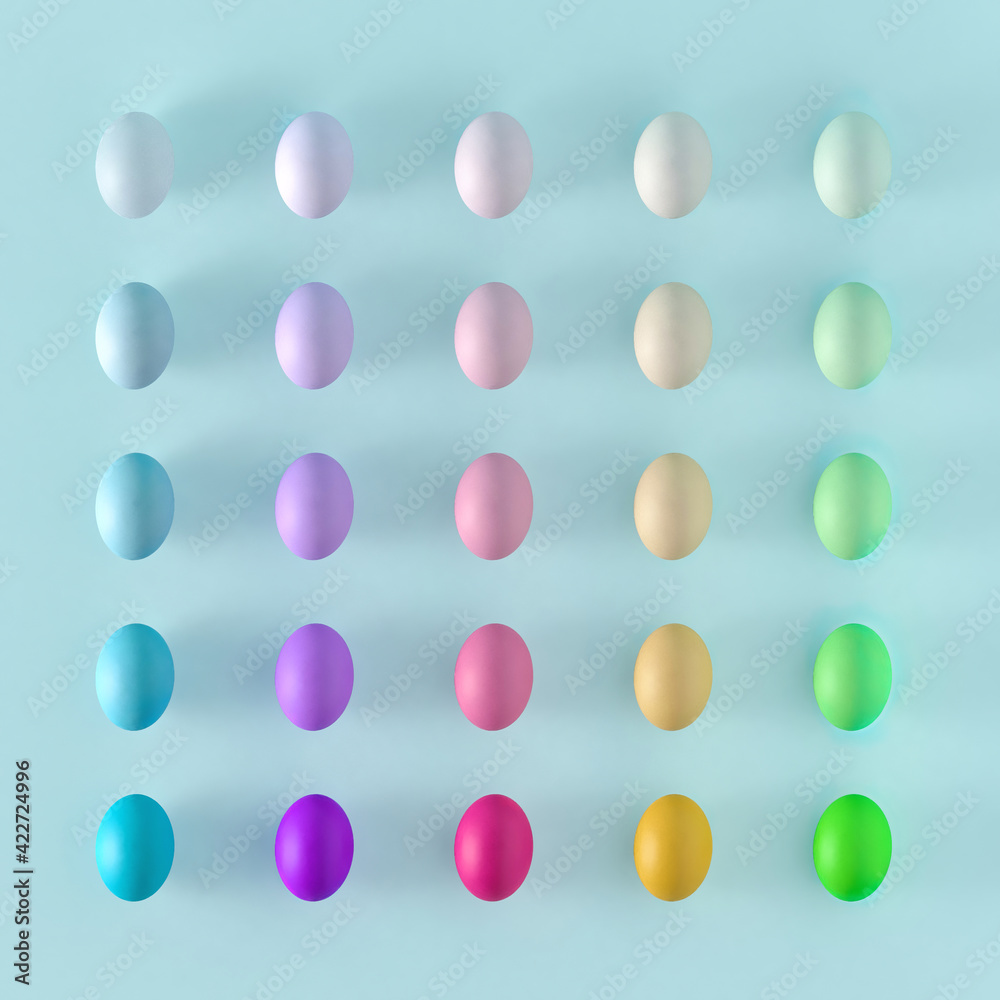 Spring flat lay pattern on soft blue background.Creative colorful pastel ombre Easter eggs centerpiece. Spring flat lay pattern on soft blue background.Creative colorful pastel ombre Easter eggs centerpiece.