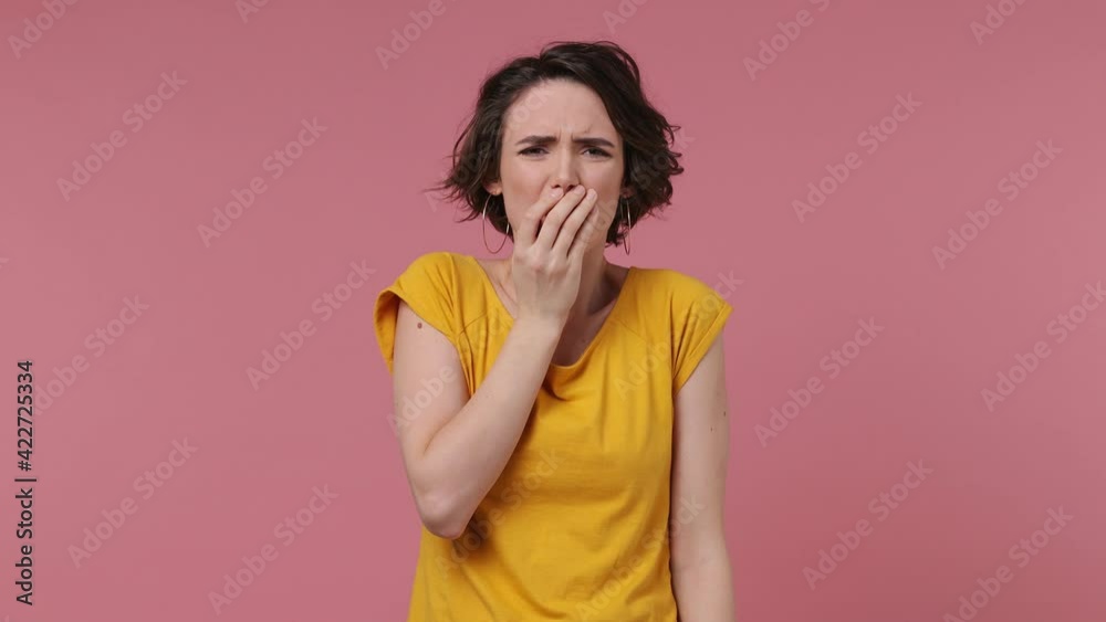 Scared shocked short hairdo young woman 20s wears basic casual yellow t-shirt looking camera covering hiding face with hands isolated on pastel pink background studio People emotions lifestyle concept Scared shocked short hairdo young woman 20s wears basic casual yellow t-shirt looking camera covering hiding face with hands isolated on pastel pink background studio People emotions lifestyle concept