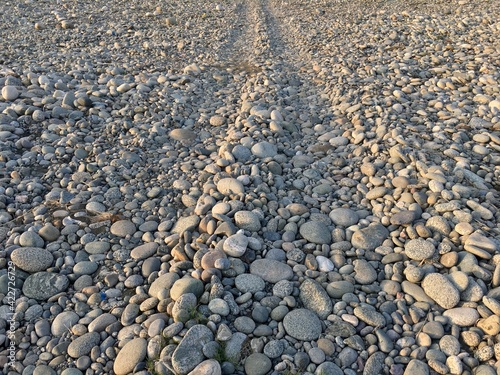 Driveway in pebbles on the riverside in the village