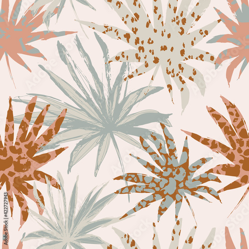 Abstract palm leaves filled with animal print. Modern trendy tropical seamles...