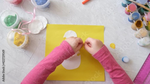 Child making card with Easter chick from colorful paper and cotton pad. Handmade. A project of children's creativity, handicrafts, crafts for kids. step 5 photo