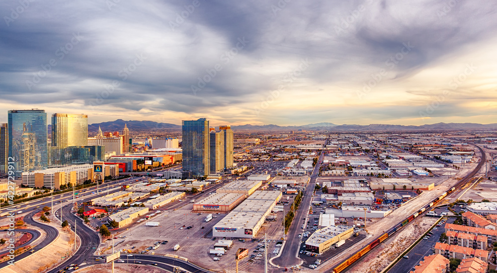 Las Vegas City Skyline panorama with sunset, mountain, luxury hotels and streets.