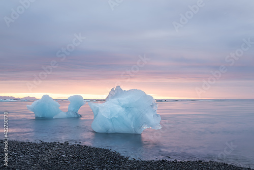 Ice floe in the water by the ocean at sunrise. glacial lagoon. Iceland. long exposure with blurry water.