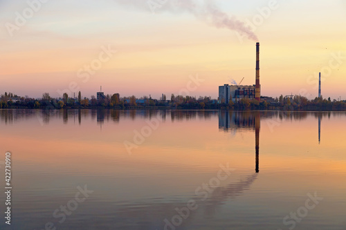 Kyiv recycling plant at sunset. chimney smokes. lake Vyrlytsia, Kiev, Ukraine © Hennadii