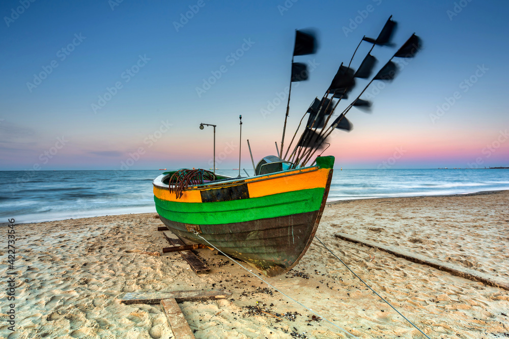 Amazing sunset with fishing boats at the beach of Baltic Sea in Sopot, Poland Amazing sunset with fishing boats at the beach of Baltic Sea in Sopot, Poland