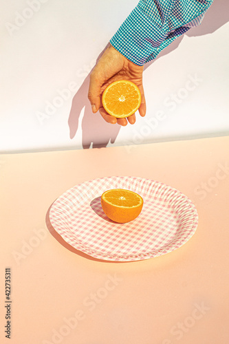 Human hand holding oranges at vintage scene