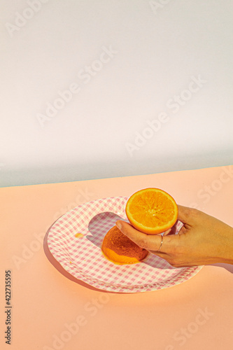 Human hand holding oranges at vintage scene