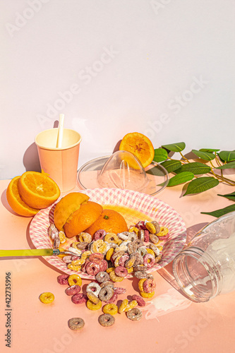 Studio shot of disastrous breakfast at vintage kitchen with colors cereals with milk and oranges
