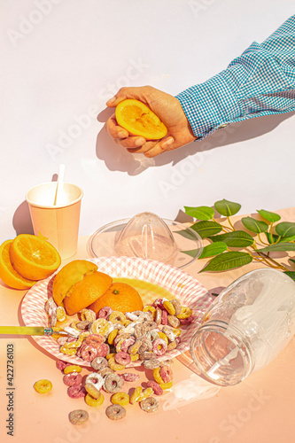 Arm of woman squeezing oranges at vintage kitchen