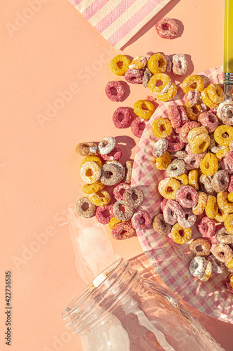 Top view of desastrous breakfast with colors cereals and milk