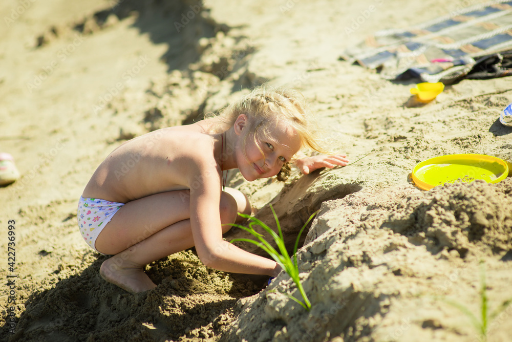 toddler playing on sandy beach, selective focus toddler playing on sandy beach, selective focus