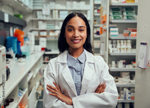 Portrait of happy professional female pharmacist in chemist