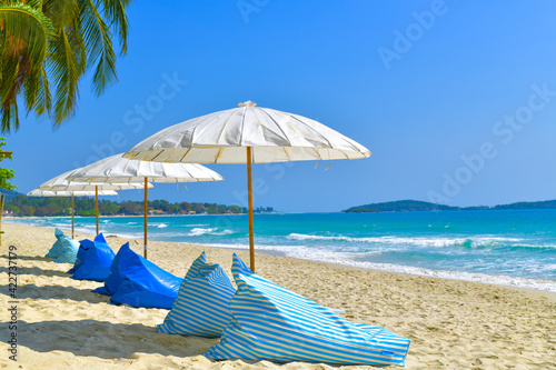 Beach umbrella and lounge chairs at Chaweng beach in koh samui ,Thailand. photo