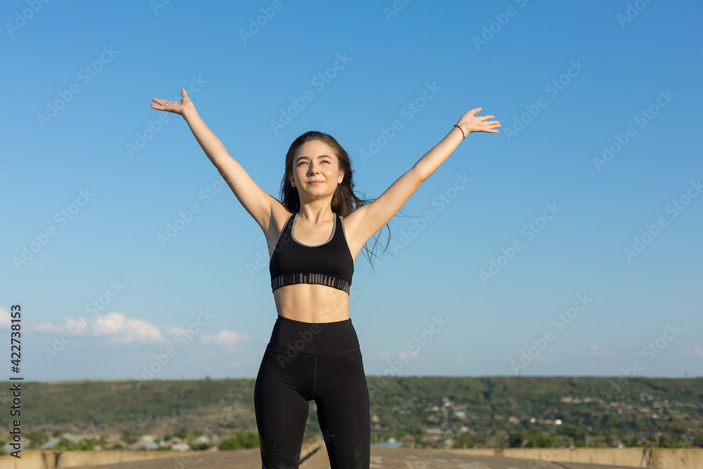 A young slim athletic girl in sportswear performs a set of exercises. A young slim athletic girl in sportswear performs a set of exercises.