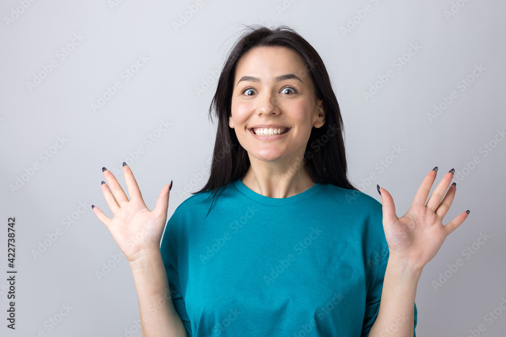Young beautiful woman with facial expression of surprise standing over gray background. Young beautiful woman with facial expression of surprise standing over gray background.