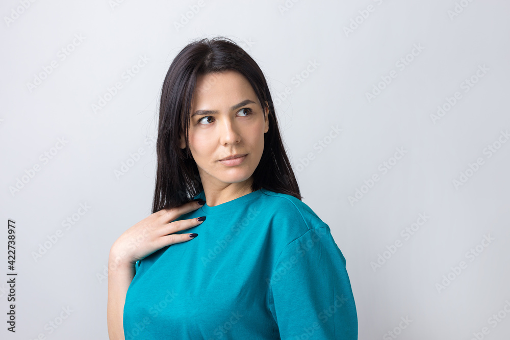 Young beautiful woman with facial expression of surprise standing over gray background. Young beautiful woman with facial expression of surprise standing over gray background.
