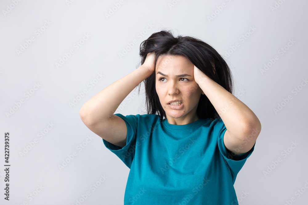 Portrait of attractive lady holding hands on head. Human face expressions and emotions. Portrait of attractive lady holding hands on head. Human face expressions and emotions.