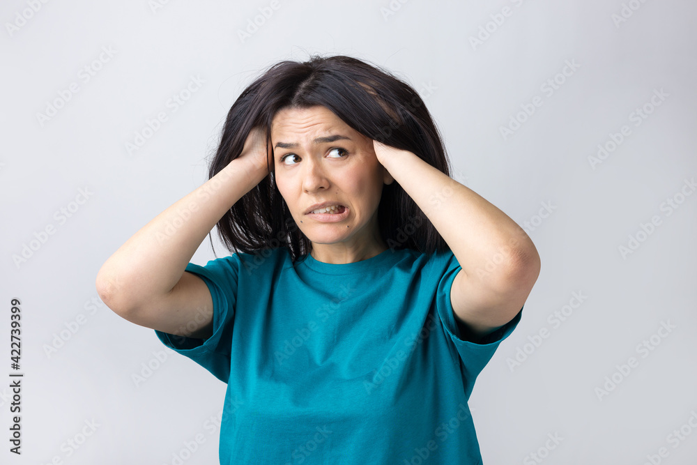 Portrait of attractive lady holding hands on head. Human face expressions and emotions. Portrait of attractive lady holding hands on head. Human face expressions and emotions.