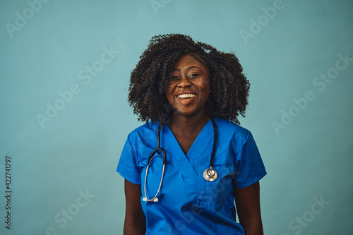 woman doctor smiling with stethoscope looking front