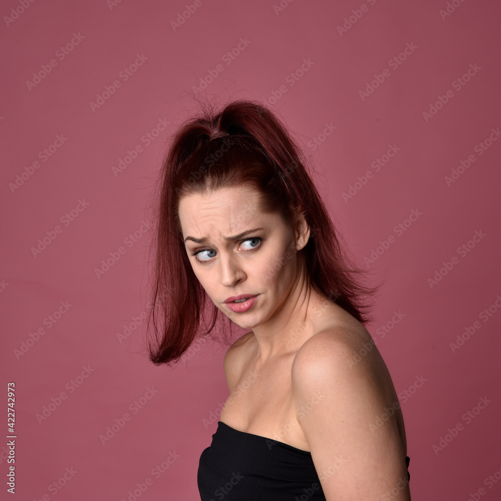 close up portrait of red haired women with different facial expressions on a pink studio background. close up portrait of red haired women with different facial expressions on a pink studio background.