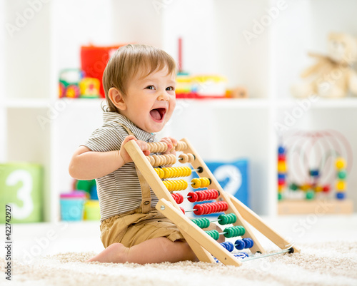 Fotografie, Obraz Little child boy playing with toy blocks