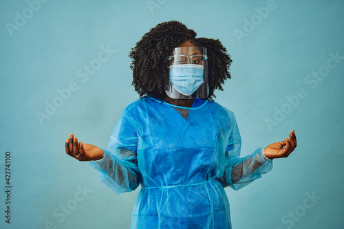 Nurse practitioner with personal protective equipment face shield goggles both hands out covid 19