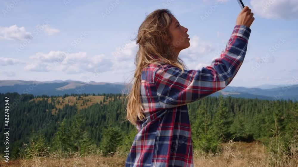 Upset hiker missing mobile network in mountains. Sad girl trying to call phone Upset hiker missing mobile network in mountains. Sad girl trying to call phone