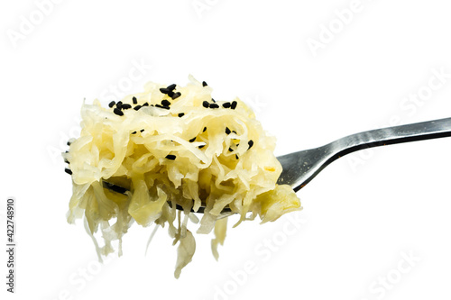 Sauerkraut with caraway seeds on fork isolated on white background