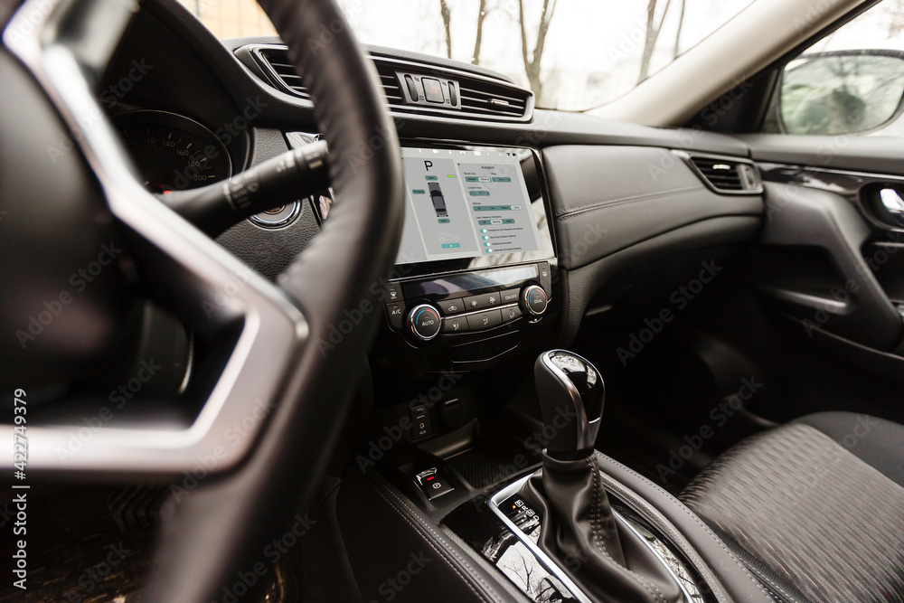 Person using digital tablet screen in a smart car Person using digital tablet screen in a smart car