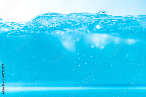 Water wave with bubble of air, on white background. Blue water