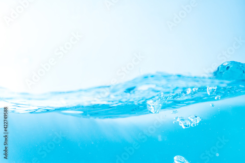 Water wave with bubble of air, on white background. Blue water