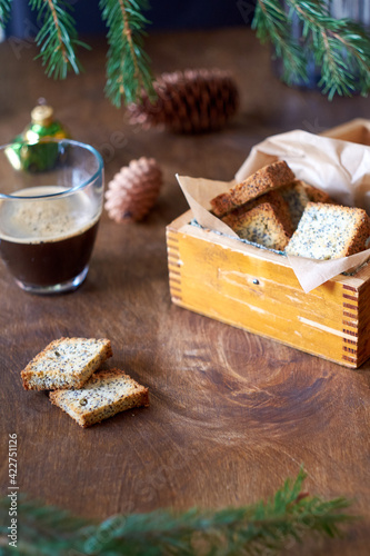 Cookies with poppy seeds. Crackers. Coffee, spruce branches, cones. Side view.