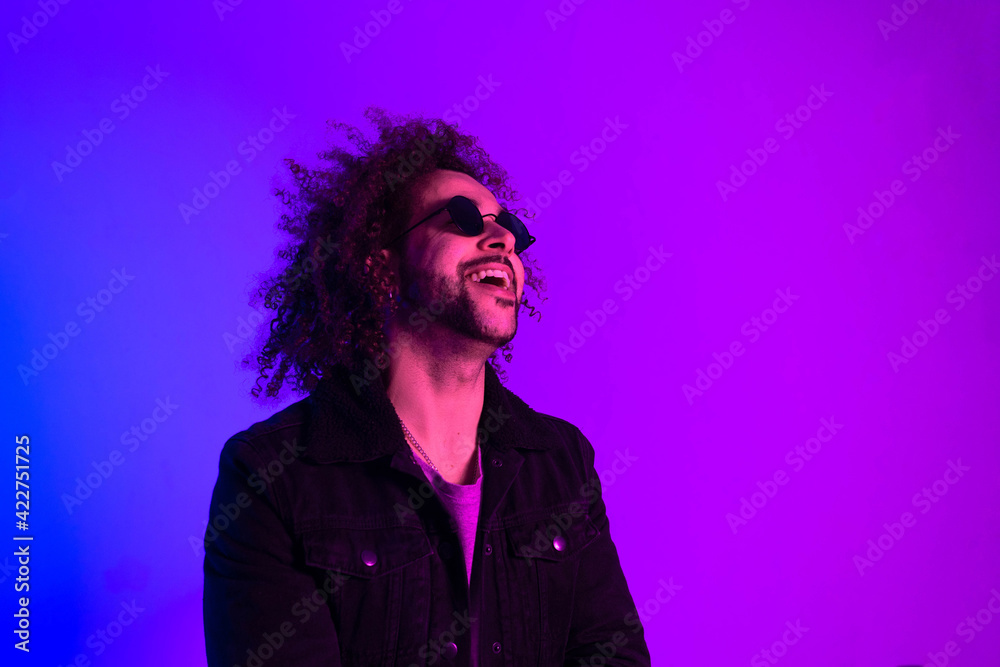 Portrait of an Afro-American hipster man, afro hair, in the style of the 80s and 90s, steampunk glasses, blue and purple neon lights. smiling and laughing Portrait of an Afro-American hipster man, afro hair, in the style of the 80s and 90s, steampunk glasses, blue and purple neon lights. smiling and laughing