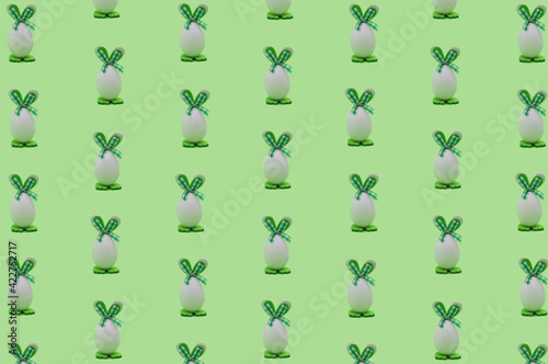 Creative easter pattern made of easter eggs with green  bunny ears.  Minimal holiday concept. © Studio Barun