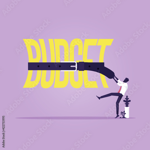 Tight budget and recession shrinking economy concept, Saving money, Businessman use belts tighten budget word, economy concept