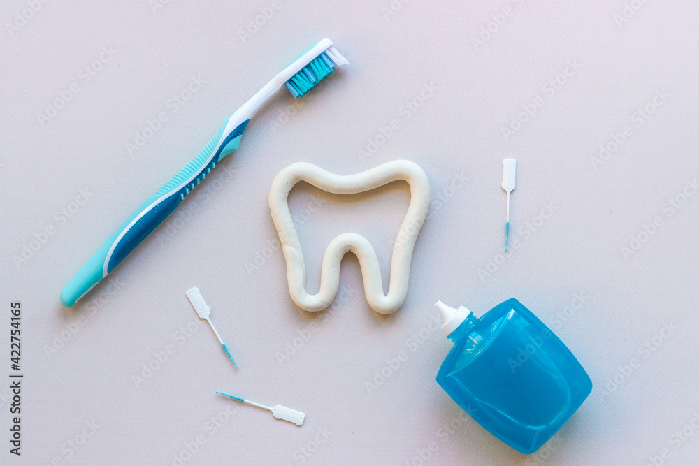 Teeth care and dental hygiene. Toothbrush with tube of toothpaste, flat lay