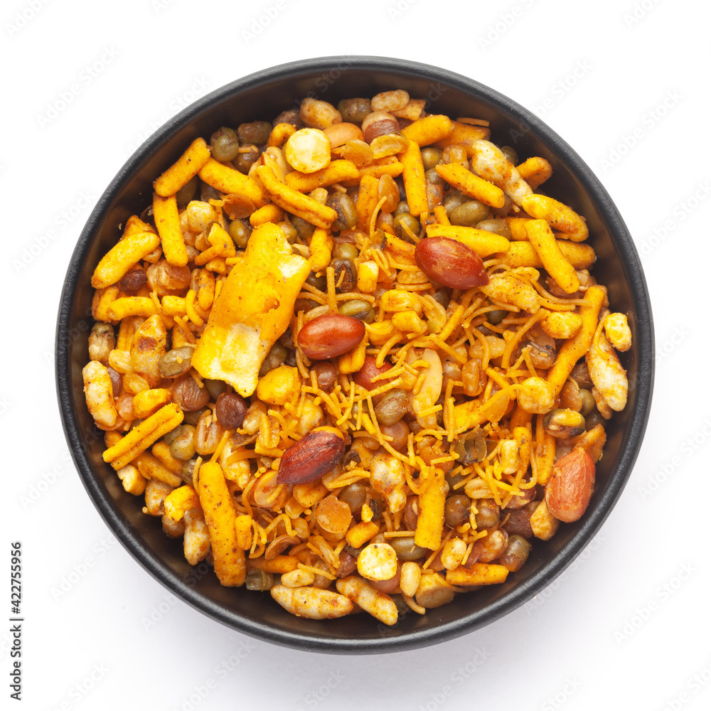 Close up of spicy Ratlami mixture Indian namkeen (snacks) on a ceramic black bowl. Top view Close up of spicy Ratlami mixture Indian namkeen (snacks) on a ceramic black bowl. Top view