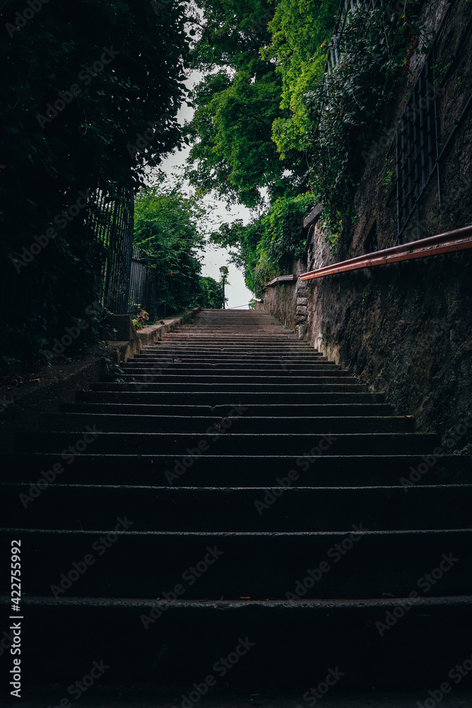 Part of the stairs leading over the Austrian city of Salzburg overlooking the old and the new part of this large Austrian city. Penetration through darkness. Purgatory
