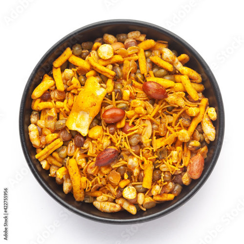 Close up of spicy Ratlami mixture Indian namkeen (snacks) on a ceramic black bowl. Top view