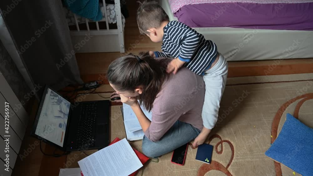 The child interferes with the mother's work at the computer The child interferes with the mother's work at the computer