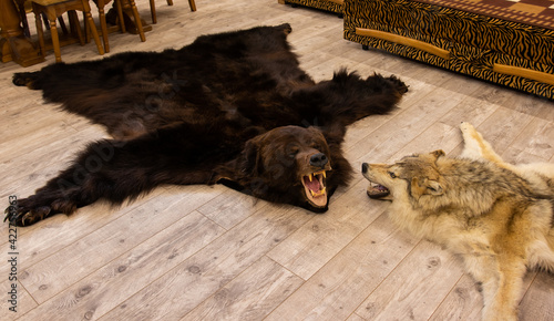 bear and wolf skins on the floor in the hunter's room