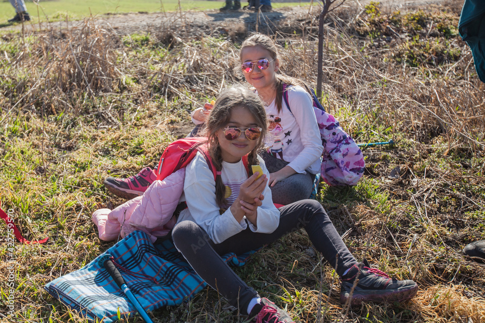 Two little girls relax in nature. Enjoying spring day Two little girls relax in nature. Enjoying spring day