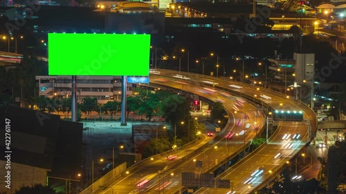 4K Time lapse: Billboard green screen with city night traffic lights background. Bangkok thailand