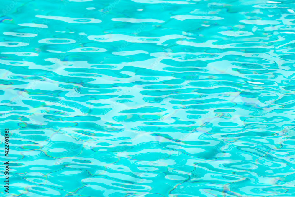 Ripple Water in swimming pool with blue tile floor background Ripple Water in swimming pool with blue tile floor background