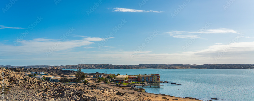 Luderitz overlooking a tranquil sea in the rugged, rocky terrain of Lüderitz, Namibia.